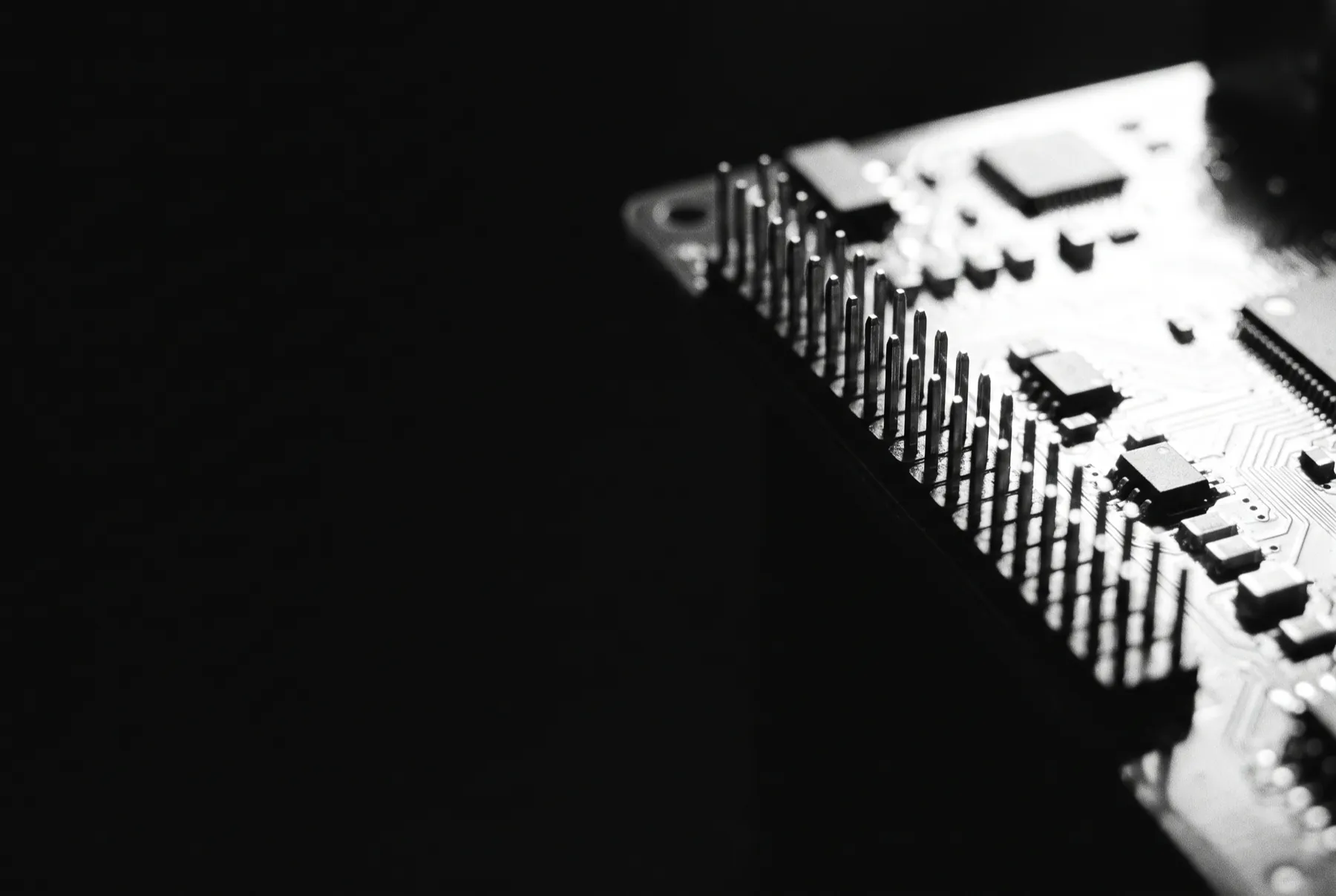 Macro detail of a circuit board under raking light